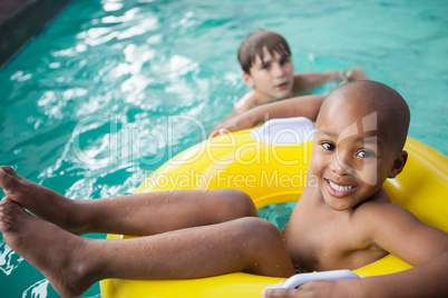 Little boys swimming with rubber ring