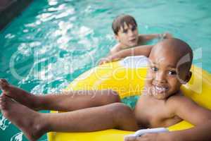Little boys swimming with rubber ring