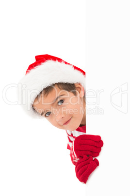 Festive little boy showing a card