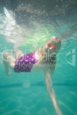 Cute kid posing underwater in pool