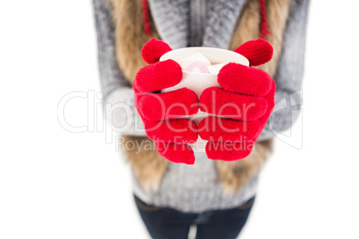 Woman in winter clothes holding a mug