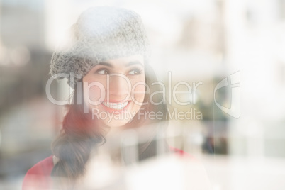 Portrait of a smiling brunette in grey hat