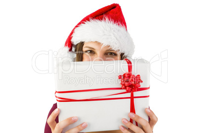 Festive brunette holding christmas present with bow