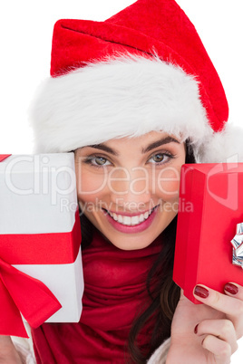 Festive brunette showing christmas gifts