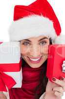 Festive brunette showing christmas gifts