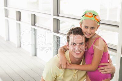 Swimming coach with cute little girl