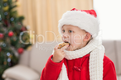 Festive little boy eating a cookie