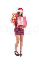 Pretty woman in santa hat opening a gift smiling at it
