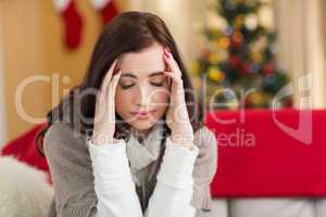 Brunette getting a headache on christmas day