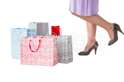 Mid section of woman with shopping bags
