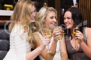 Happy friends drinking champagne together