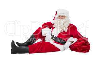 Relaxed santa sitting and leaning on his sack