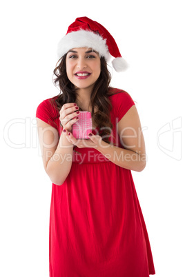 Brunette in santa hat holding gift