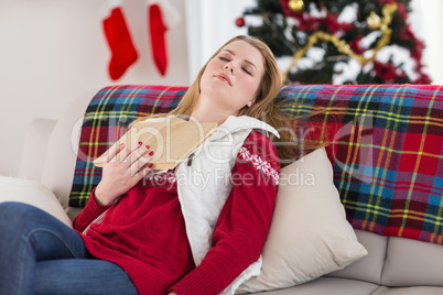 Young woman falling asleep while reading