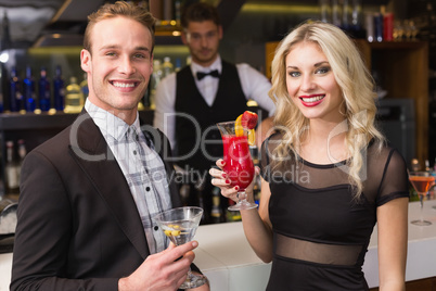 Attractive friends drinking cocktails together