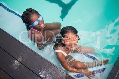 Cute little kids sitting poolside