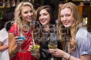 Happy friends having a drink together