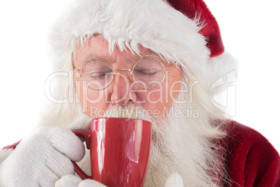 Santa drinks from a red cup