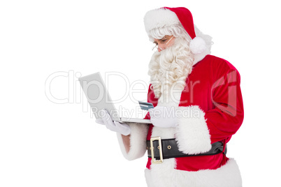 Santa claus shopping online with laptop