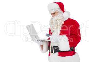 Santa claus shopping online with laptop