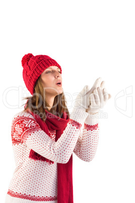 Woman in warm clothing blowing over hands
