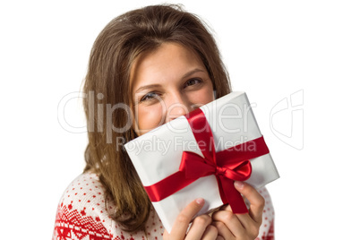Smiling brunette holding a gift with red ribbon