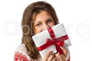 Smiling brunette holding a gift with red ribbon