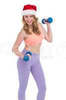 Festive fit blonde posing with dumbbells