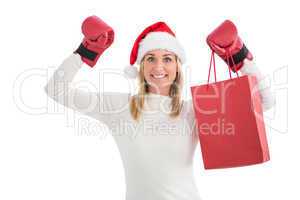 Festive blonde in boxing gloves with shopping bag