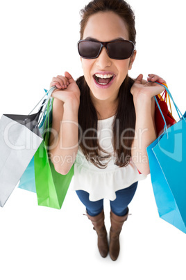 Excited brunette holding shopping bags