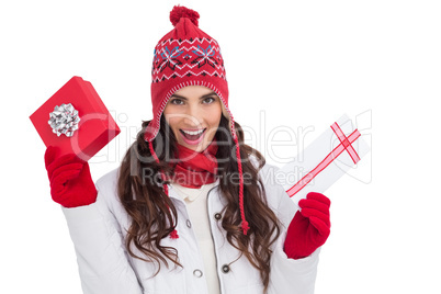 Festive brunette in winter clothes holding gifts