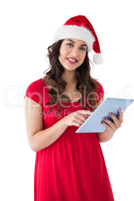 Brunette in santa hat using her tablet