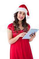 Brunette in santa hat using her tablet