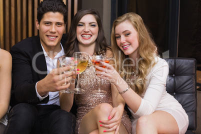 Happy friends having a drink together