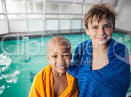 Little boys smiling by the pool