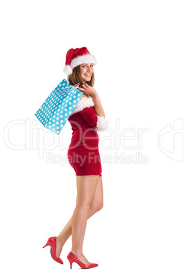 Festive brunette holding shopping bags