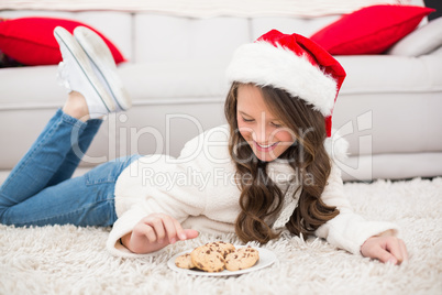 Festive little girl eating cookies