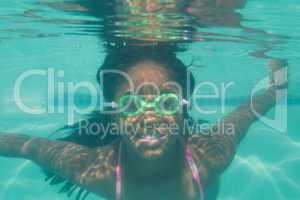 Cute kid posing underwater in pool