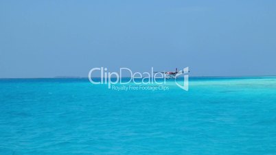 Seaplane makes landing on water. Maldives Indian Ocean.