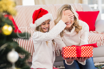 Festive mother and daughter with gift