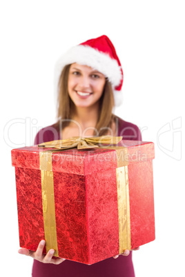 Young woman giving a christmas present with bow