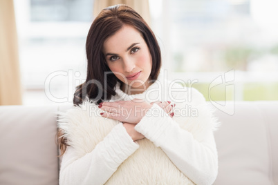 Beauty brunette holding a cushion