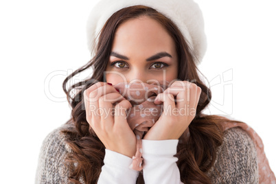 Brunette in winter clothes holding her scarf