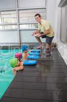 Cute swimming class listening to coach