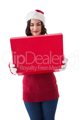 Smiling brunette in winter clothes opening gift
