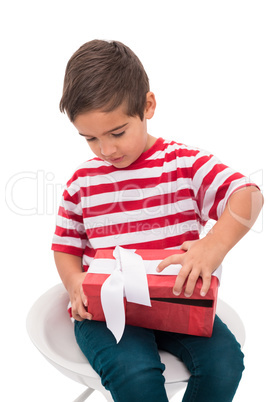 Cute little boy opening gift