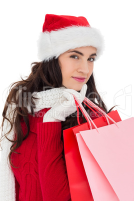 Pretty brunette in winter wear holding shopping bags