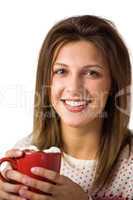 Pretty woman holding a cup of coffee sitting on the sofa