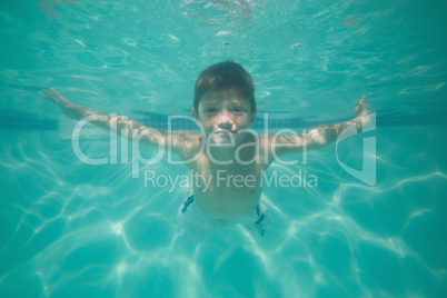 Cute kid posing underwater in pool