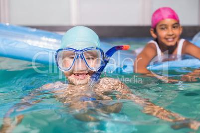 Cute little kids swimming in the pool